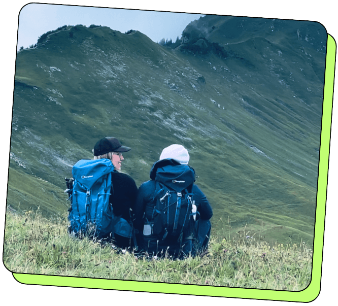 Claire and Sebastian sitting together in the Austrian mountains